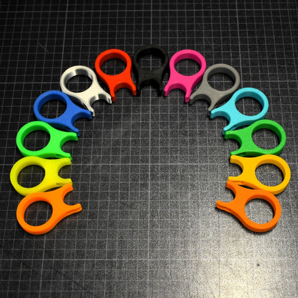 Colorful plastic tools arranged in a circular pattern on a grid background