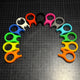 Colorful plastic tools arranged in a circular pattern on a grid background